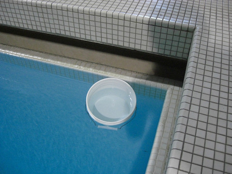 You can see how the blue color of water amplifies with volume in this photo of a bucket floating in a swimming pool.