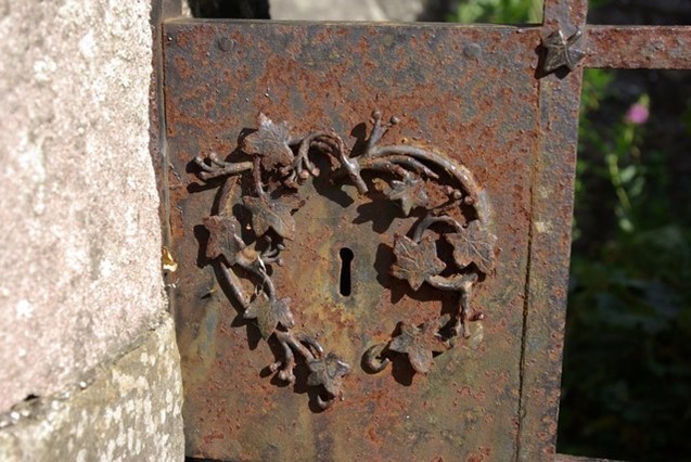 Rust forms on an intricately decorated iron lock