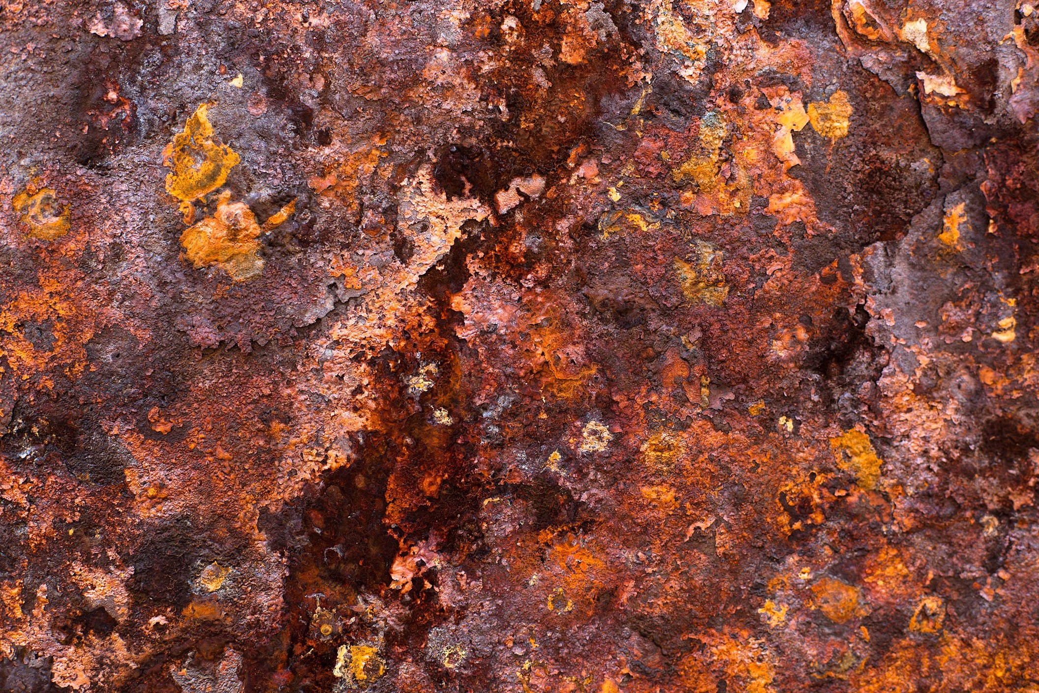 Layers of rust flake off of exposed iron metal