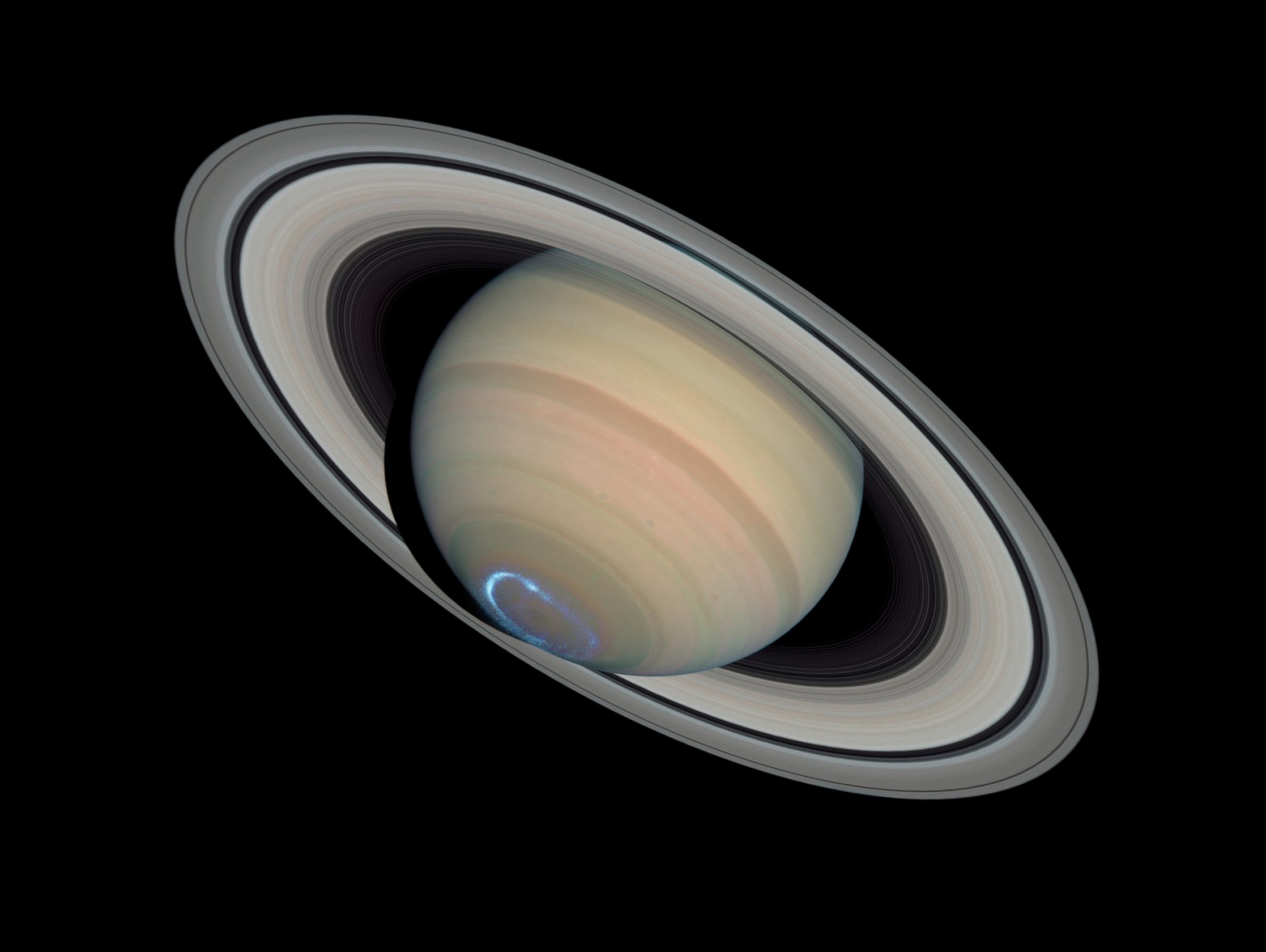 Saturn with a false-color image of ultraviolet aurora