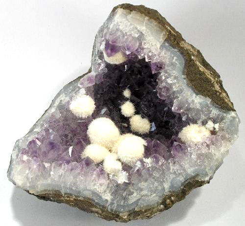 A geode containing balls of mordenite with very delicate needles that grew and were preserved in the void.